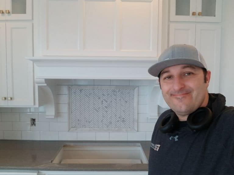 Smiling contractor with backsplash